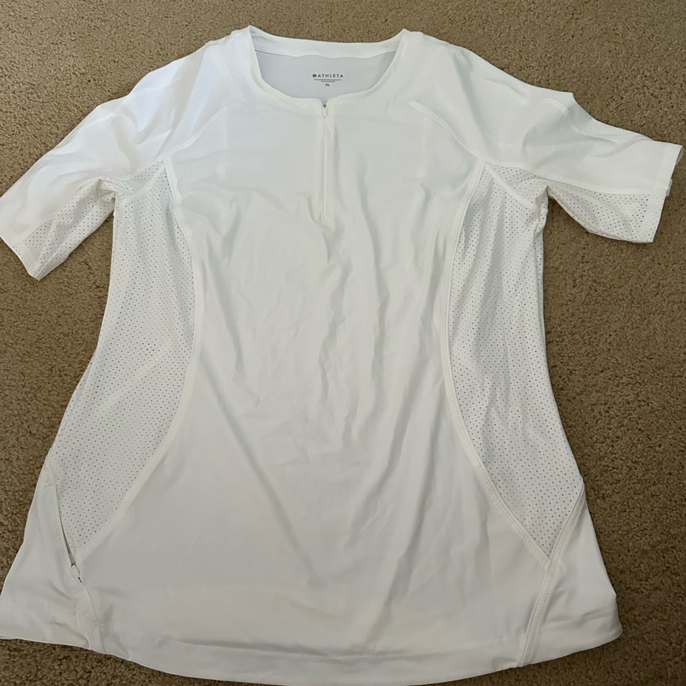 Athleta white half zip, short sleeve, wicking top with mesh inserts.